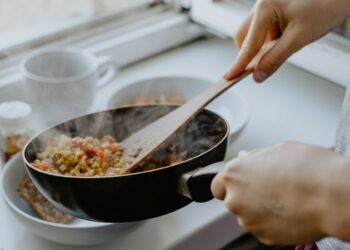 person holding black frying pan