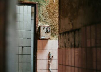brown metal gate with red metal chain