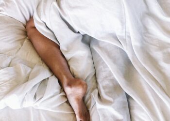 woman covered with white blanket