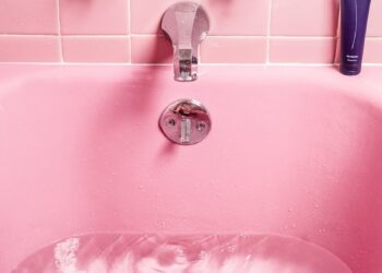white bathtub filled with water
