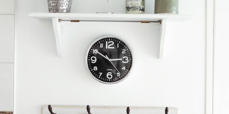 round white analog clock at 3:50
