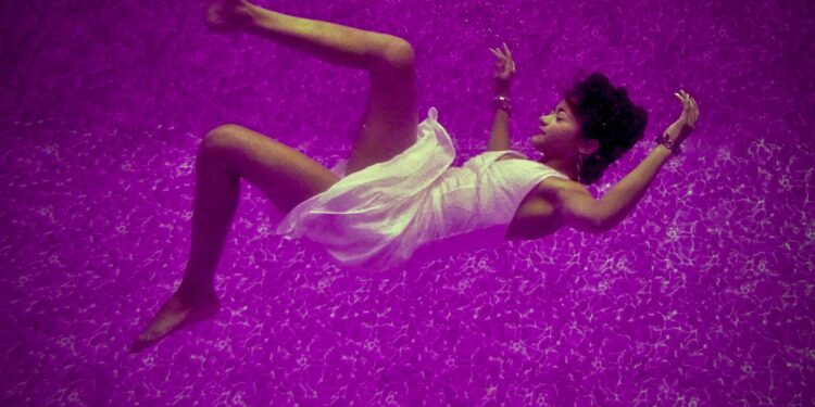 woman falls on purple surface